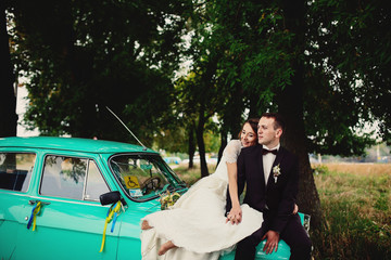 Young newlyweds on the old vintage car