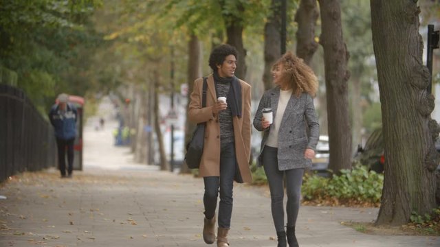 Stylish Couple Walk On Fall Street In City In Slow Motion