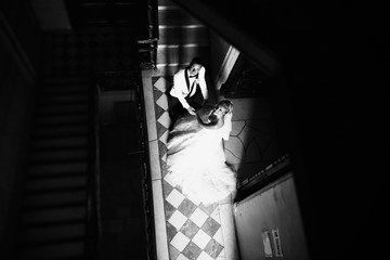 Bride and groom together next to the stairs
