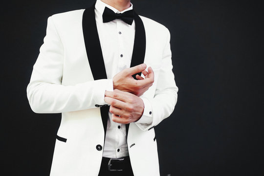 Stylish white jacket and a black bow-tie
