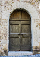 The entrance wooden door in an old Italian house.