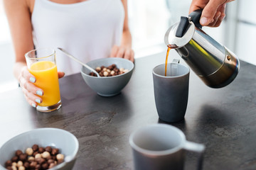 Man having breakfast with his girlfriend on the kitchen