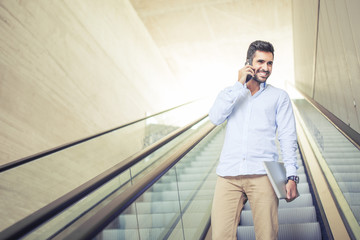 Young man with devices escalating
