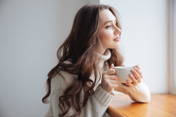 Woman in sweater with tea