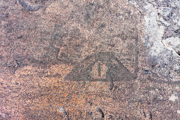 Ancient petroglyphs (rock engravings of 4th-2nd millennia BC) that depict duck carved on granite Onega Lake shore. Besov Nos cape, Karelia Republic, Russia.
