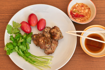 Tasty roasted pork with fresh vegetable and Thai style sauce