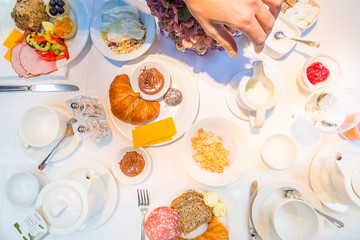 Family Breakfast Scene, Toast, Jam, Croissant, Fresh Juice, Snacks and Sweets on Table, Top view