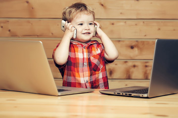 Cute smiling boy talks on phones