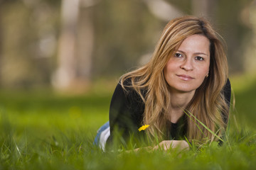 Young female sitting on grass