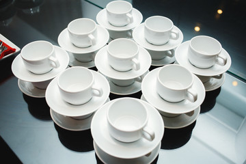 served with cups and saucers on the table