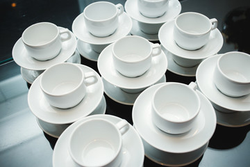 served with cups and saucers on the table