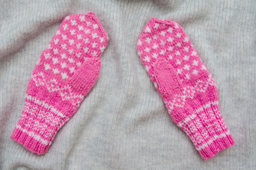 Pink Mittens with a pattern on a soft warm background