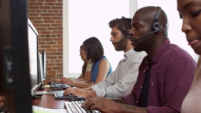 Staff At Desks In Customer Service Department Shot On R3D
