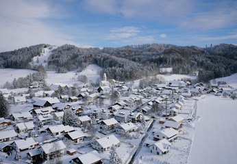 aerial photo of village in winter