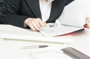 Businesswoman Holding Magnifying Glass