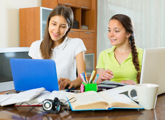 Two female students studying at home.