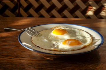 Fried eggs on the tray with the light blue platter