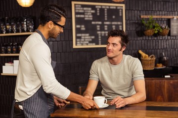 Waiter serving a coffee 