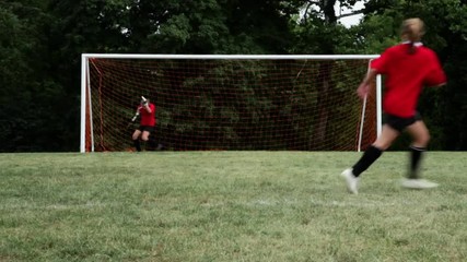 Soccer player hitting crossbar with ball