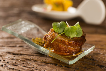 Pork ballotine with pururuca, water flour, pumpkin puree and sprouts in a spoon. Taste gastronomy fingerfood