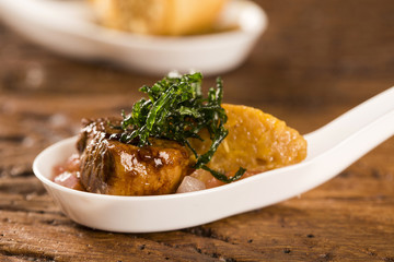 Pork mignon with creamy canjiquinha and vinaigrette in a spoon. Taste gastronomy fingerfood