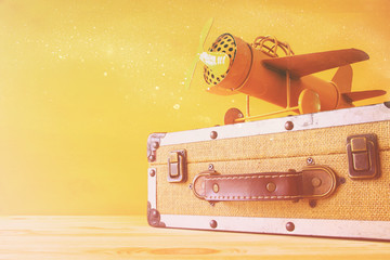 vintage toy plane and old suitcase on wooden table