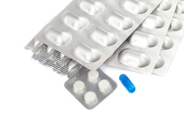 Pills in blister packs on white background.
