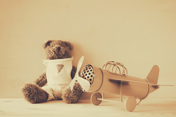 Photo of vintage toy plane and cute teddy bear