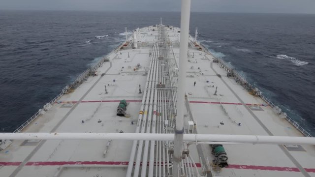 Supertanker sails in ocean top view