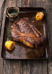 Grilled Black Angus Steak Ribeye  with rosemary and corn on iron