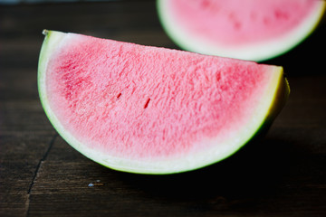 Small watermelon, piecies of delicious ripe watermelon on wooden board