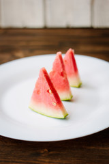 Small pieces of watermelon on white plate.