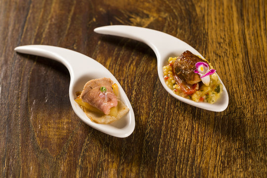 Roast beef, grilled pineapple, macauba and basil flower in a spoon. Taste gastronomy finger food