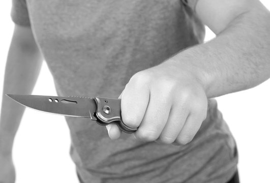 Young man holding knife isolated on white background