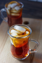 Glass of rum and cola with the ice cubes and slice of orange.