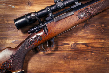 Sniper on wooden background