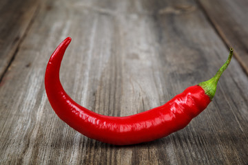 Red hot peppers on wooden background