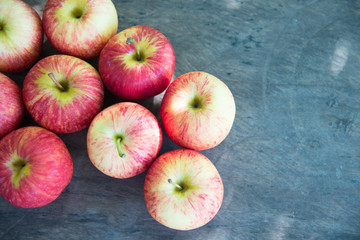 Ripe red apples on wooden background