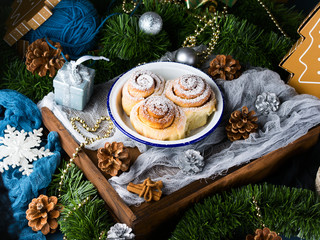 Cinnamon roll buns in enamel bowl with Christmas decorations