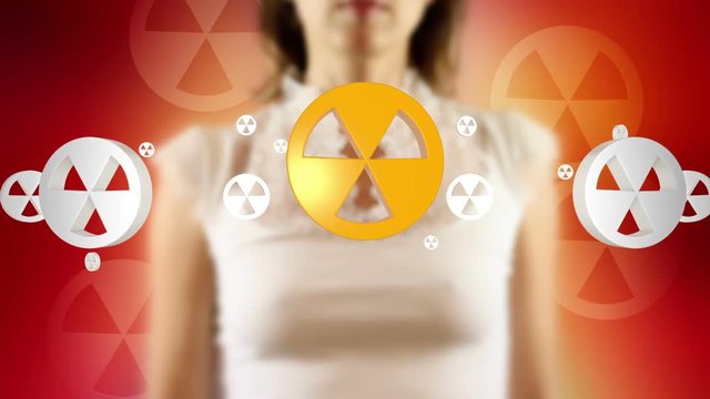 Young female pressing the screen then nuclear symbol appearing