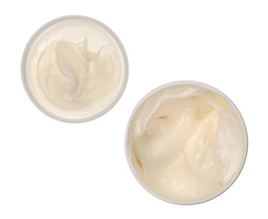 Container of cocoa butter cream skin lotion with lid isolated on a white background.