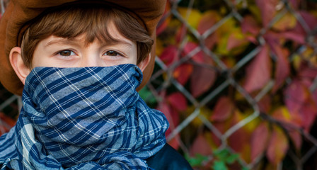 The boy hides his face plays the role of a criminal