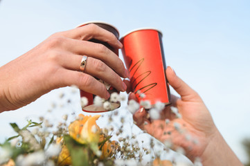 Couple Holding Paper Glasses