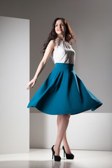 Colorful photo of a woman in white top and dark blue skirt