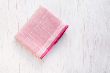 Close up hand hole linen tablecloth in red checkered for dish,
