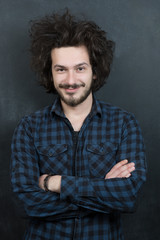 Portrait of a fashionable young man on dark background, chalkboa