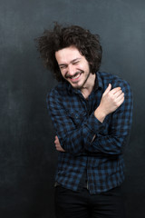 Portrait of a fashionable young man on dark background, chalkboa