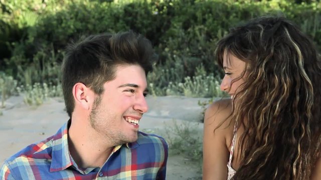 Young couple sitting on sand