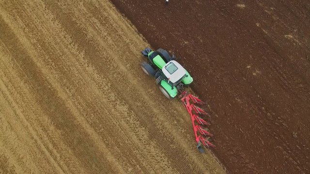 Birdseye View of a Tractor Plowing Field