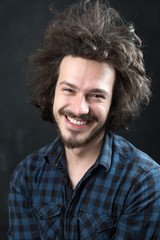 Portrait of a fashionable young man on dark background, chalkboa
